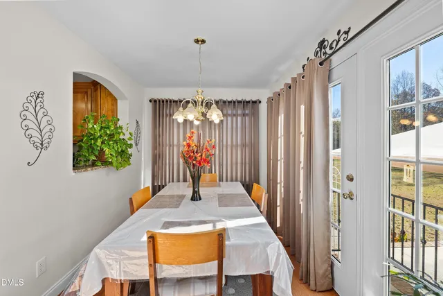 a view of a dining room with furniture wooden floor and a chandelier