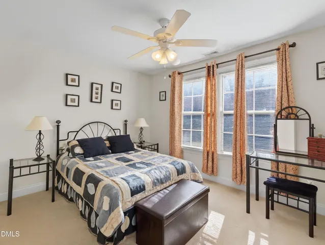 a spacious bedroom with a bed and a chandelier