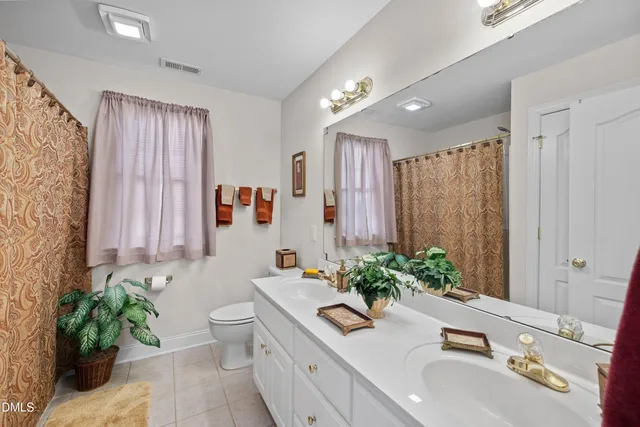 a spacious bathroom with a sink mirror and shower