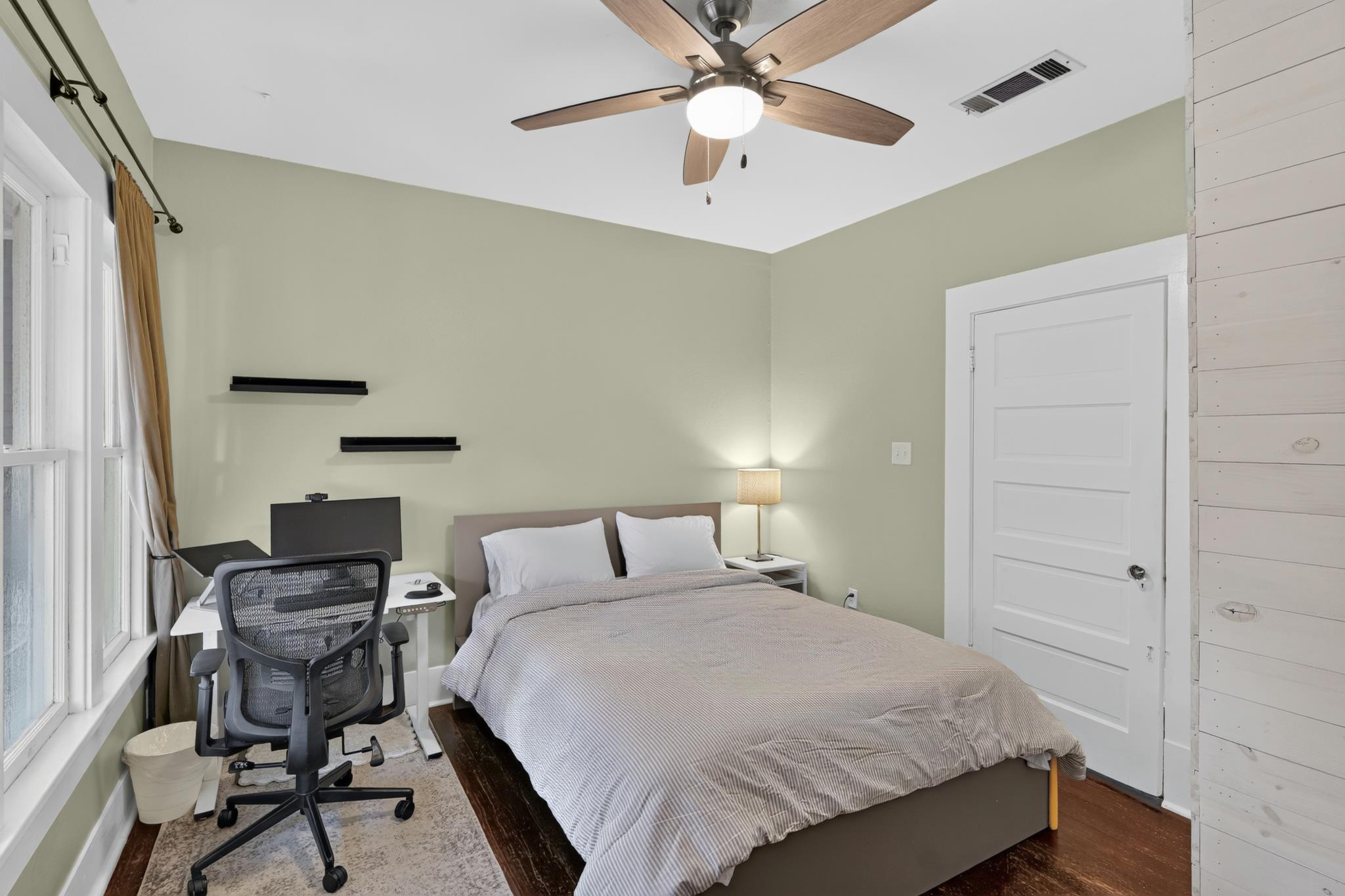 307 East 35th Street, Unit A Austin, TX 78705 - Photo 27 of 40 Well-lit sleeping quarters feature hardwood flooring and a stylish ceiling fan for year-round comfort.