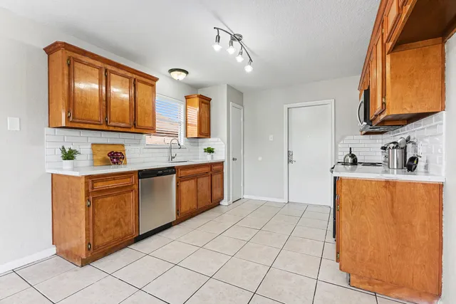 a kitchen with stainless steel appliances granite countertop a sink and cabinets