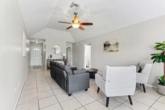 a living room with a couch and a chandelier