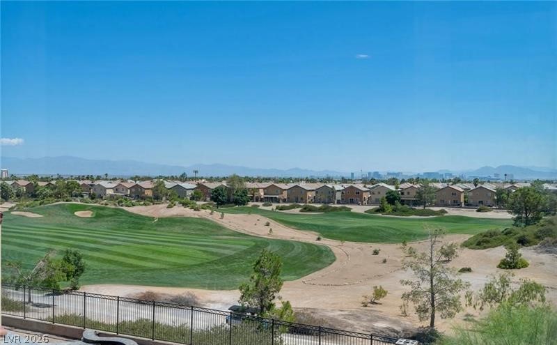 3 Tall Ruff Drive Las Vegas, NV 89148 - Photo 11 of 54 A sweeping golf course panorama unfolds beyond this home, framed by distant mountains and a city skyline.