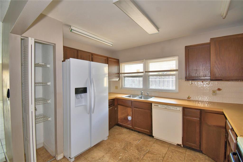 573 Hunter Circle Kissimmee, FL 34758 - Photo 14 of 36 a white refrigerator freezer sitting inside of a kitchen