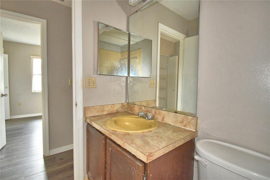 573 Hunter Circle Kissimmee, FL 34758 - Photo 19 of 36 a bathroom with a granite countertop sink and a mirror