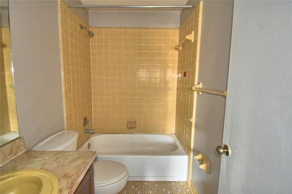 573 Hunter Circle Kissimmee, FL 34758 - Photo 20 of 36 a bathroom with a granite countertop sink toilet and shower