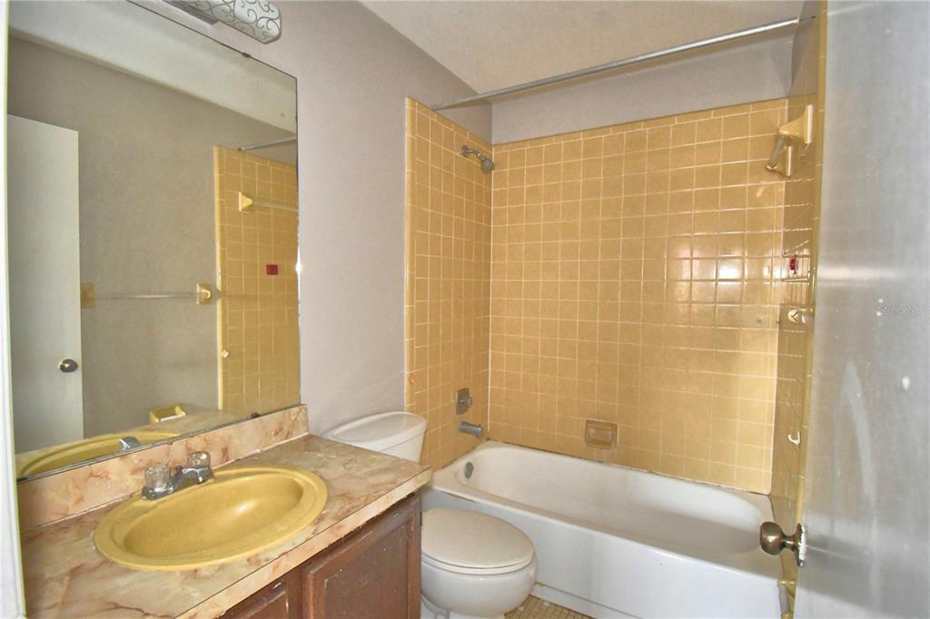 573 Hunter Circle Kissimmee, FL 34758 - Photo 21 of 36 a bathroom with a sink toilet and shower