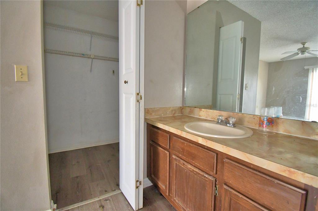 573 Hunter Circle Kissimmee, FL 34758 - Photo 24 of 36 a bathroom with a sink and a mirror