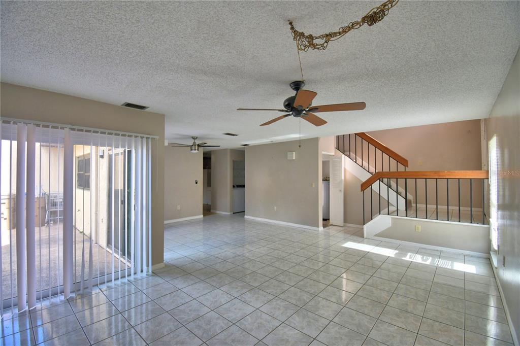 573 Hunter Circle Kissimmee, FL 34758 - Photo 5 of 36 a view of a hallway with a chandelier