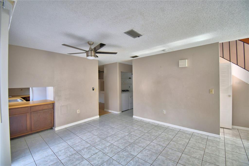 573 Hunter Circle Kissimmee, FL 34758 - Photo 7 of 36 a view of a big room with windows and cabinet