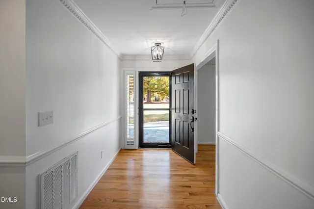 a view of a hallway view with wooden floor and staircase
