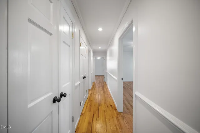 a view of a hallway with wooden floor