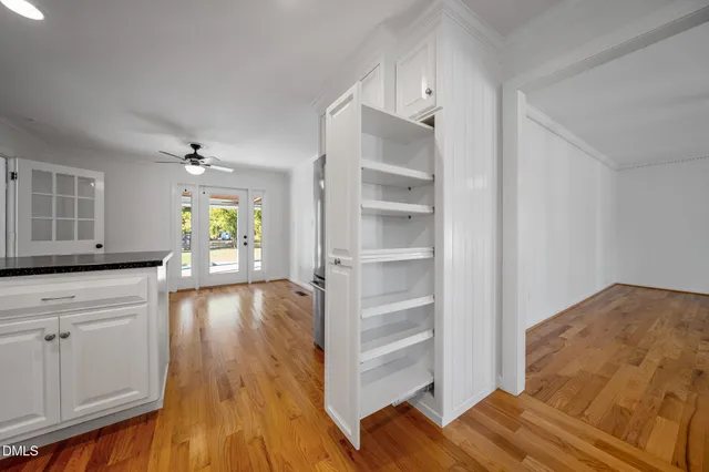 a view of a bedroom with wooden floor and closet