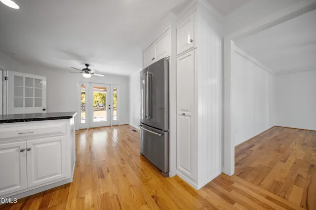 a kitchen with stainless steel appliances granite countertop a refrigerator and a stove top oven