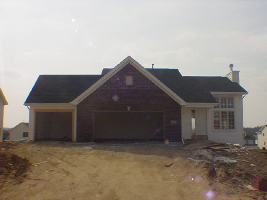 1026 Old Hunter Run Byron, IL 61010 - Photo 1 of 2 a front view of a house with a yard and garage
