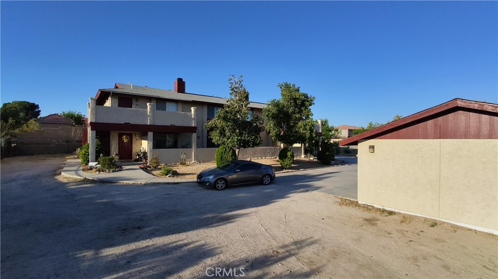 16228 Wato Road Apple Valley, CA 92307 - Photo 13 of 17 a view of a house with backyard porch and sitting area