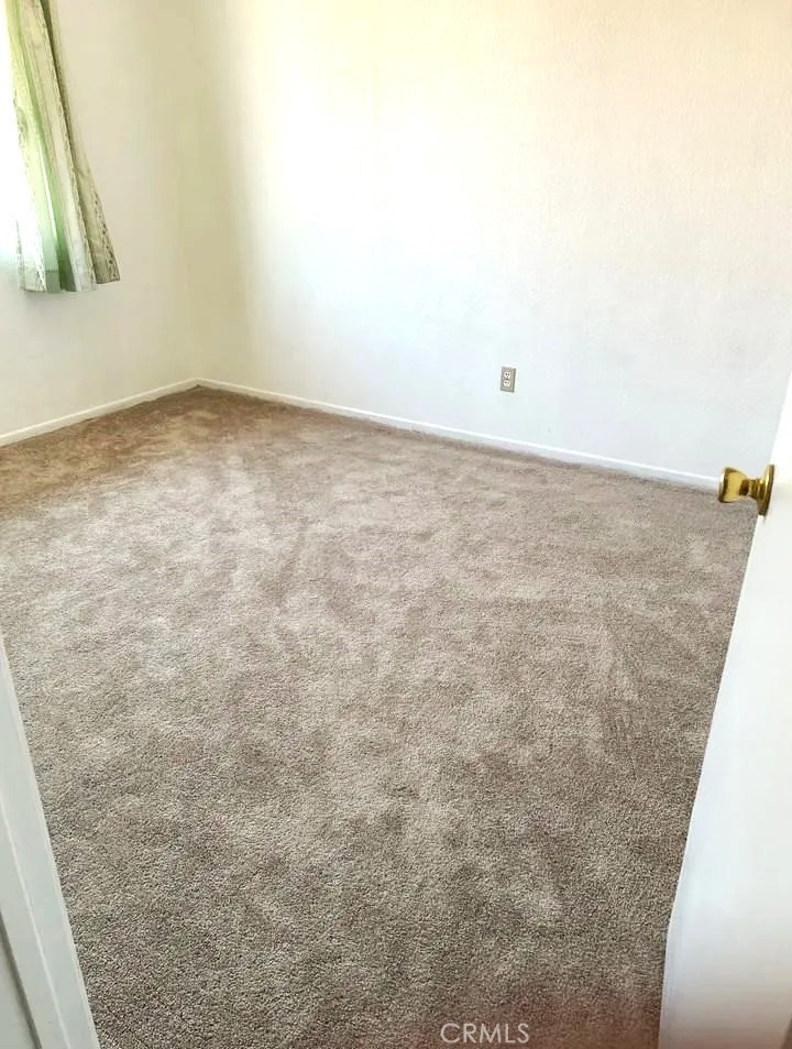 16228 Wato Road Apple Valley, CA 92307 - Photo 8 of 17 an empty room with a bench