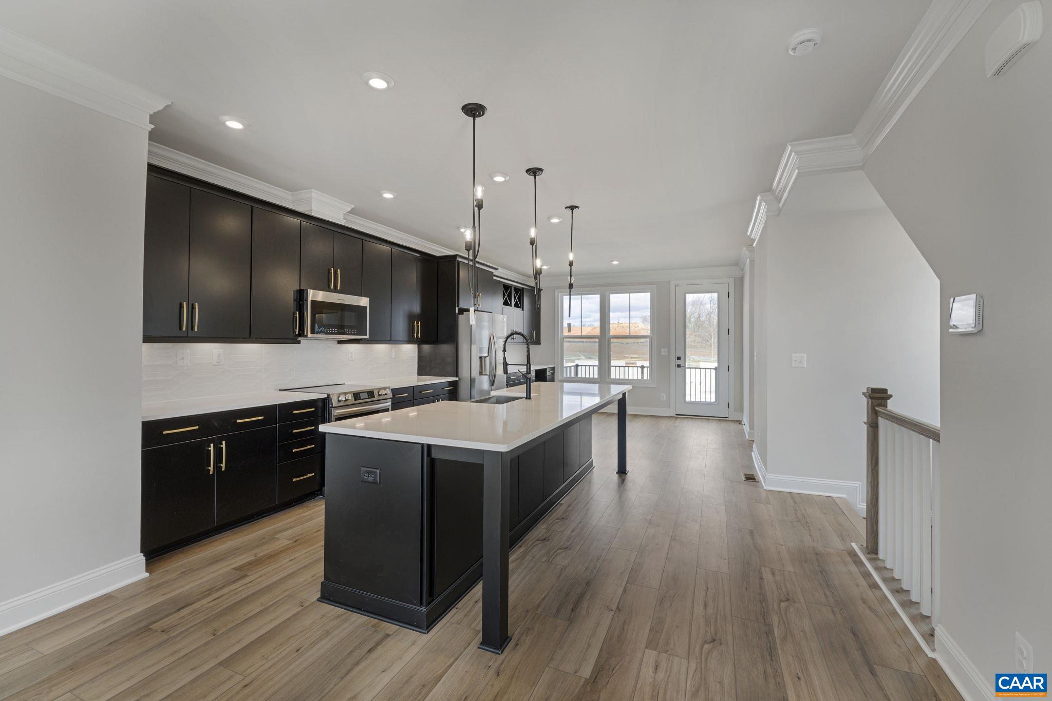 138 Park Ridge Drive Crozet, VA 22932 - Photo 13 of 51 a large kitchen with stainless steel appliances and wooden floors