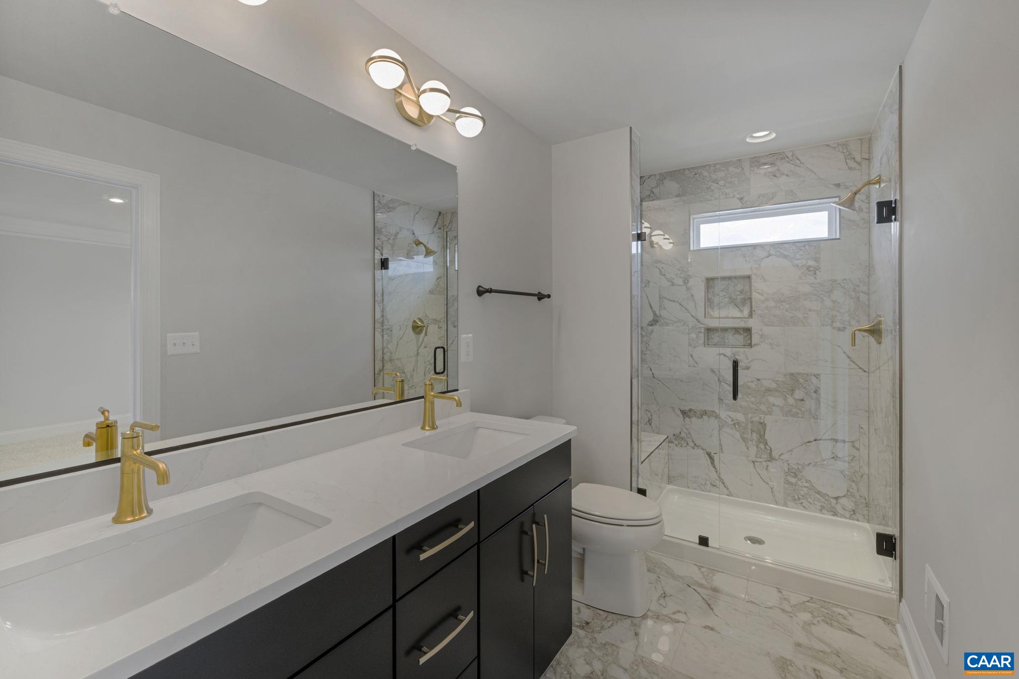 138 Park Ridge Drive Crozet, VA 22932 - Photo 27 of 51 a bathroom with a sink a toilet a mirror and shower