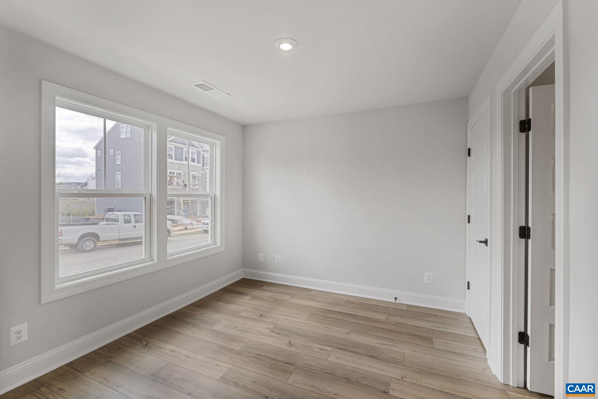 138 Park Ridge Drive Crozet, VA 22932 - Photo 6 of 51 a view of an empty room with wooden floor and a window