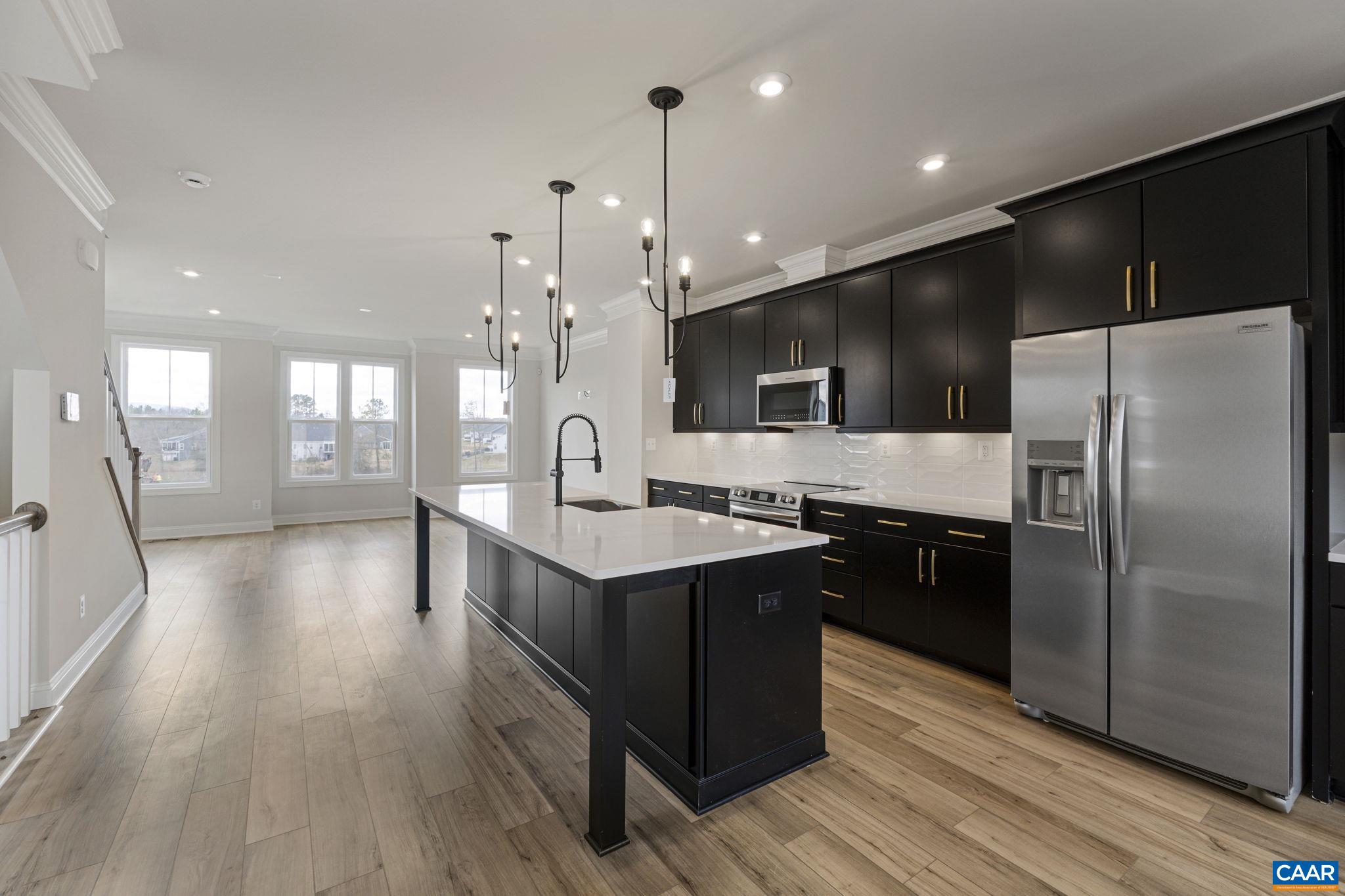 138 Park Ridge Drive Crozet, VA 22932 - Photo 10 of 51 a kitchen with stainless steel appliances kitchen island granite countertop a stove a refrigerator a sink and a oven with wooden floor