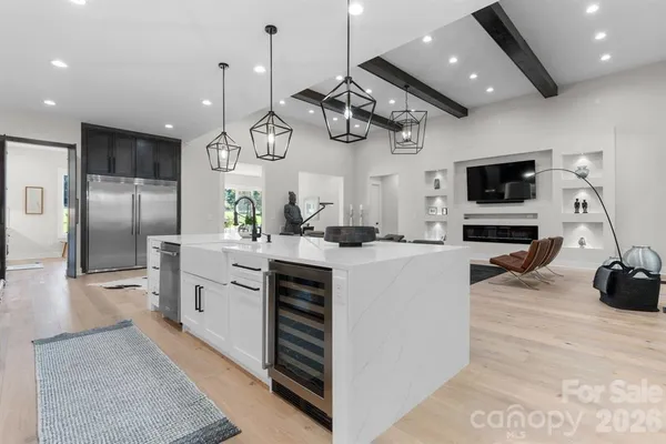 a large kitchen with stainless steel appliances kitchen island granite countertop a sink a stove and a refrigerator