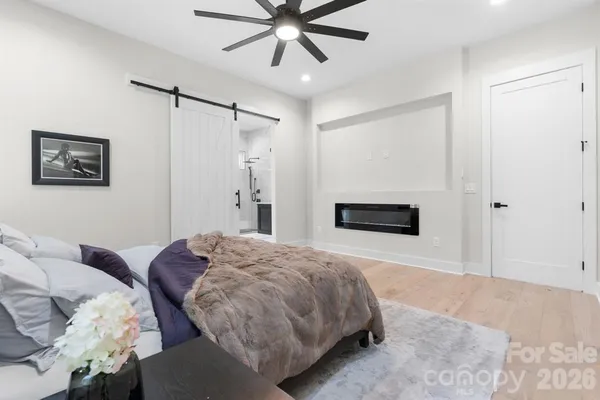 a bedroom with a bed and a chandelier