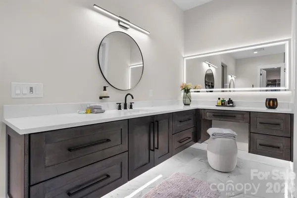 a bathroom with a double vanity sink and a mirror