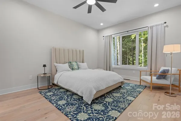 a bedroom with a bed and a chair
