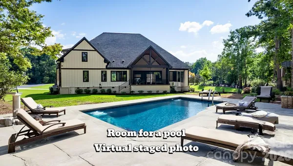 a view of swimming pool with outdoor seating and a garden