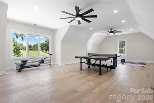 a living room with furniture a window and a chandelier