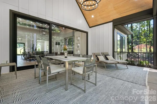 a view of a dining room with furniture wooden floor and a chandelier