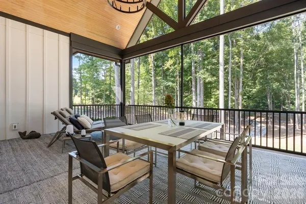 a view of a patio with a table chairs and a balcony