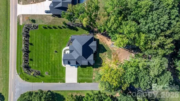 an aerial view of house with yard and swimming pool