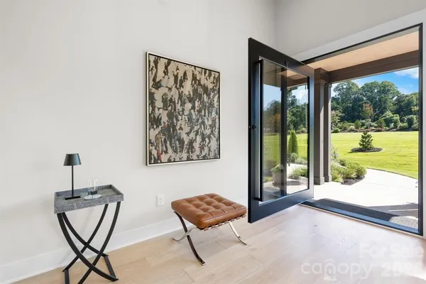 a living room with furniture and a floor to ceiling window