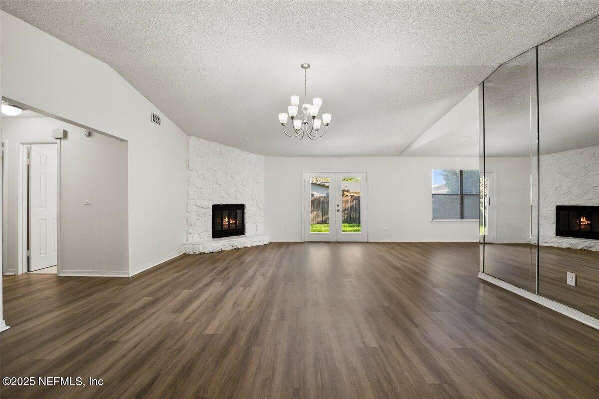 8215 Sailmaker Lane Jacksonville, FL 32210 - Photo 11 of 29 wooden floor in an empty room with a window