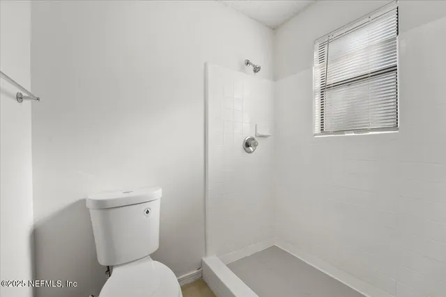 a white toilet sitting next to a bathroom sink