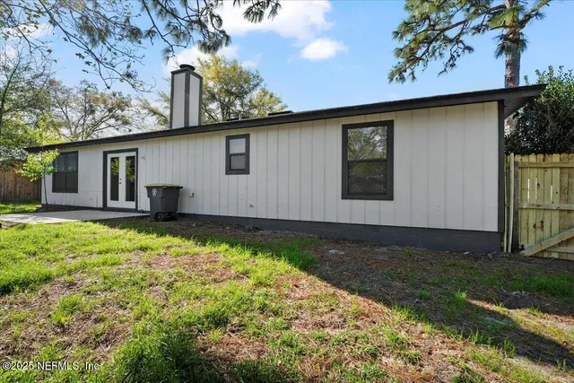 a backyard of a house with yard and outdoor seating