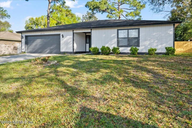 a front view of house along with trees