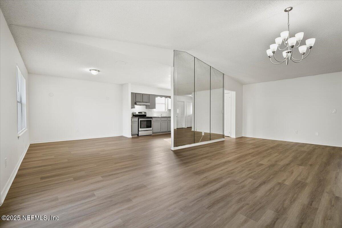 8215 Sailmaker Lane Jacksonville, FL 32210 - Photo 10 of 29 a view of empty room with wooden floor and fan