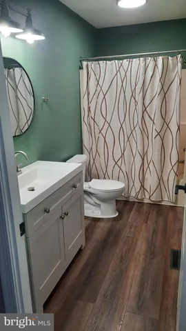 a bathroom with a toilet a sink and garden
