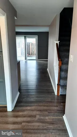 a view of entryway with wooden floor and stairs