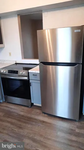 a kitchen with stainless steel appliances a refrigerator and a stove