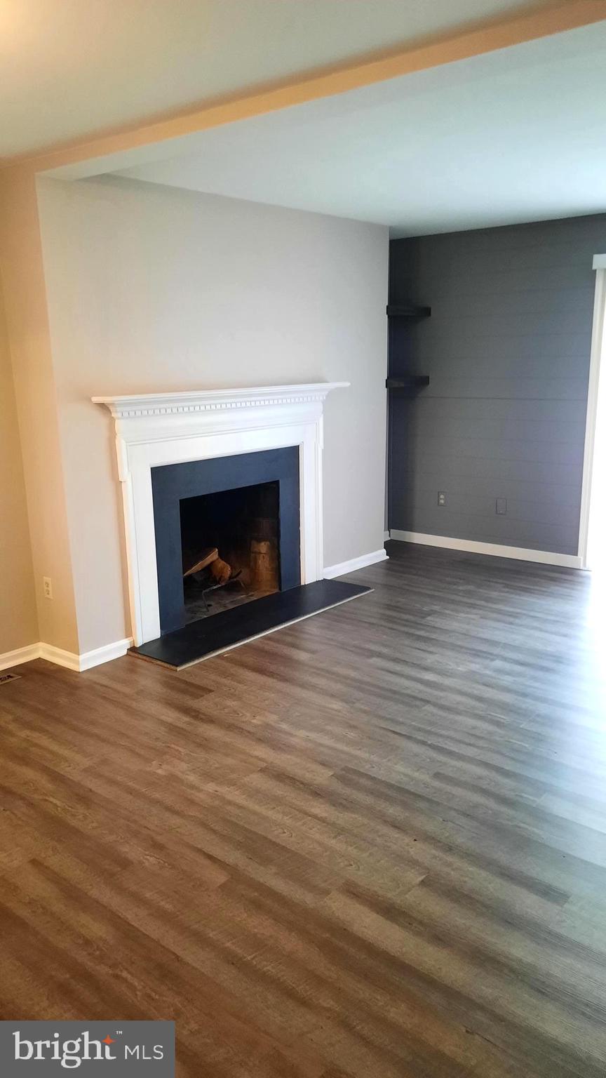 702 Allenview Drive Mechanicsburg, PA 17055 - Photo 9 of 17 a view of an empty room with wooden floor fireplace and a window