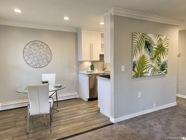 420 Terrace Road, Unit T10420 Bayport, NY 11705 - Photo 6 of 9 a view of a kitchen with a dining table and chairs