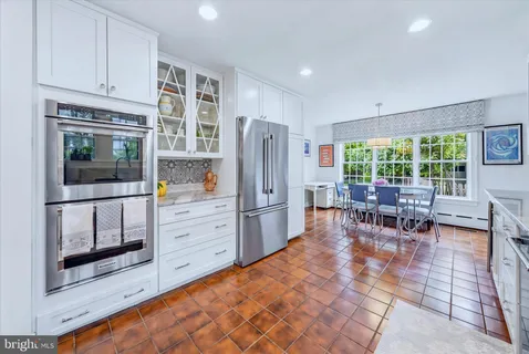 a large kitchen with cabinets and stainless steel appliances