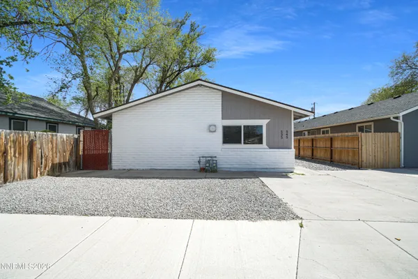 a front view of a house with trees