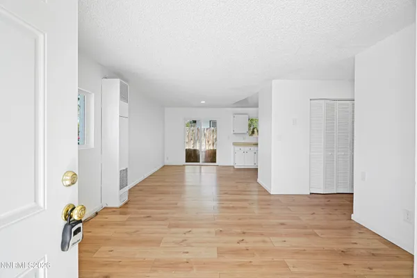 a view of empty room with wooden floor