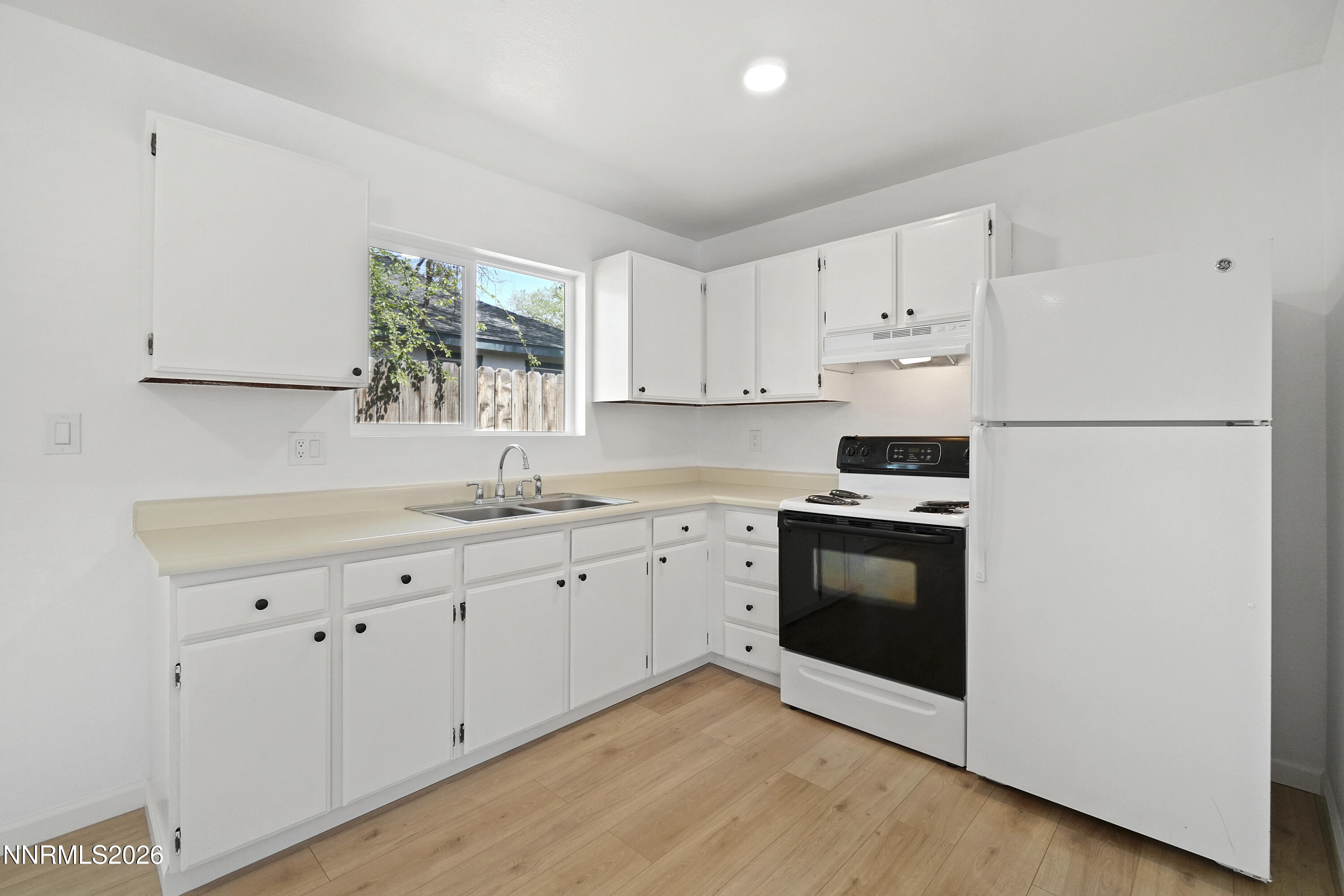 535 Churchill Street Fallon, NV 89406 - Photo 4 of 19 a kitchen with granite countertop white cabinets and white appliances