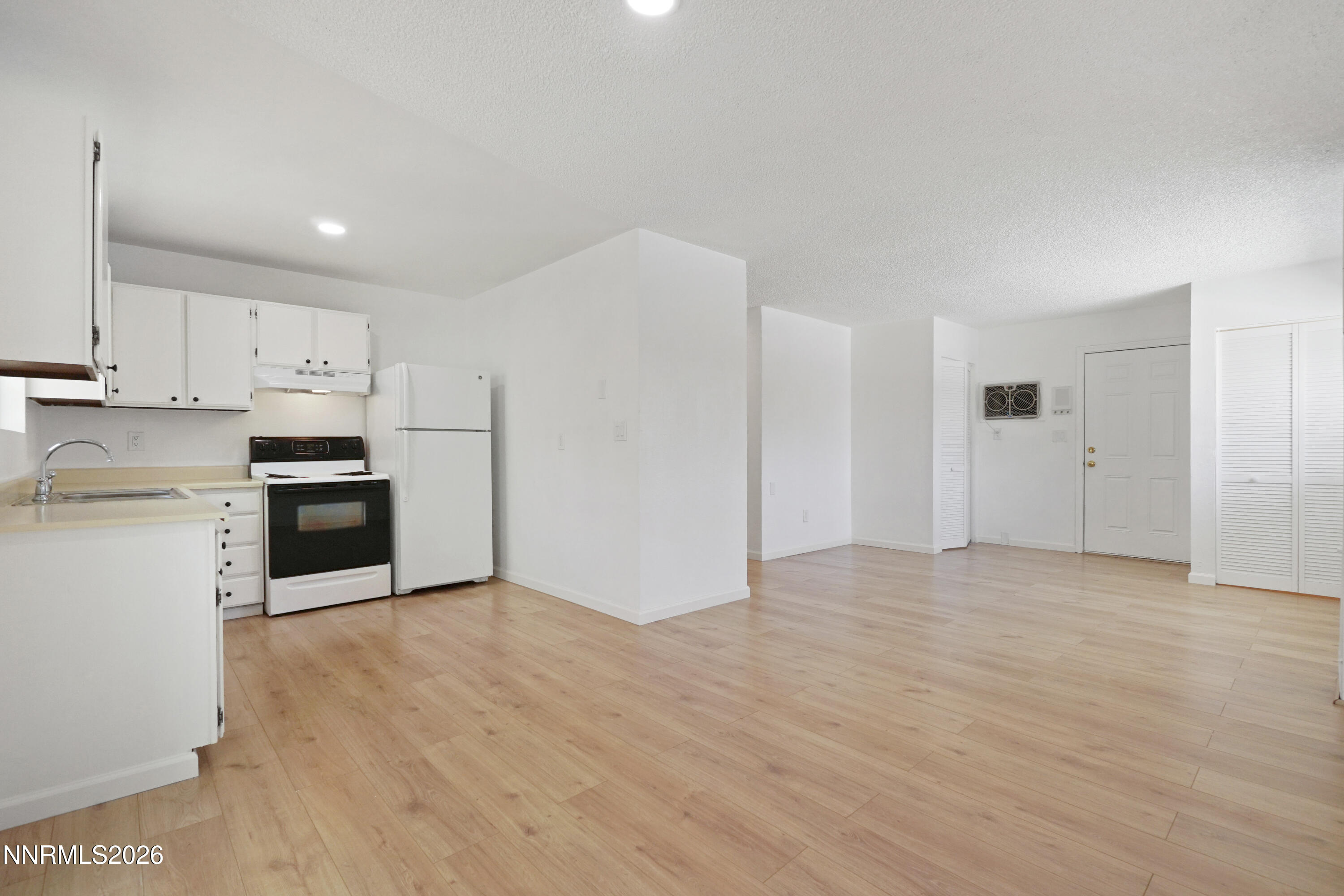 535 Churchill Street Fallon, NV 89406 - Photo 6 of 19 a kitchen with granite countertop white cabinets and stainless steel appliances